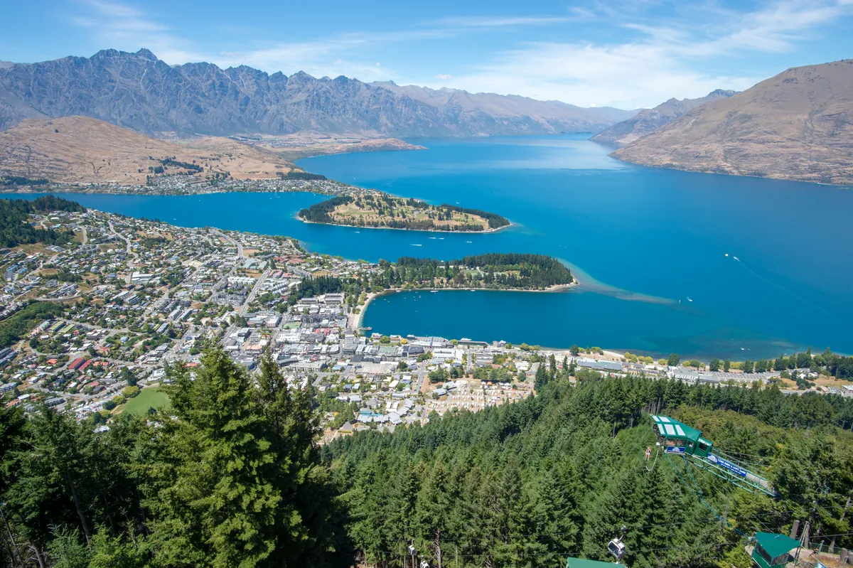 Queenstown on turquoise Lake Wakatipu ringed by mountains on a clear day